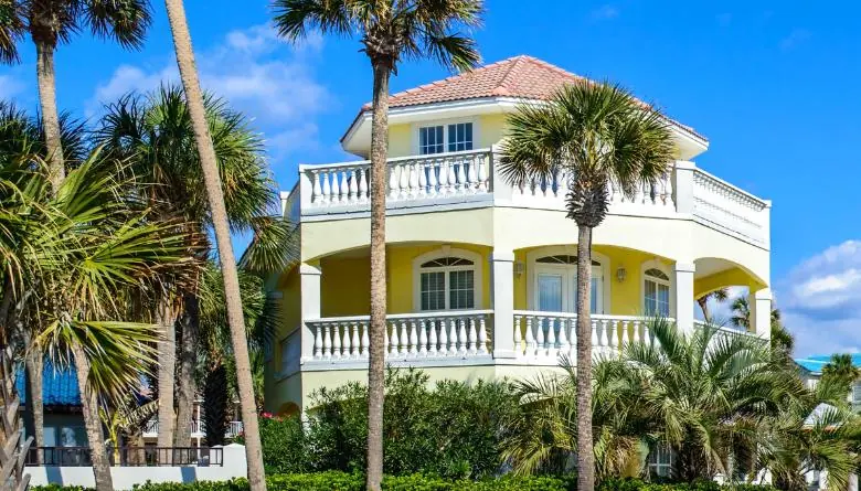 nice house next to palm trees