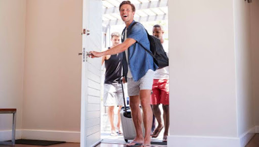 friends walking into vacation rental